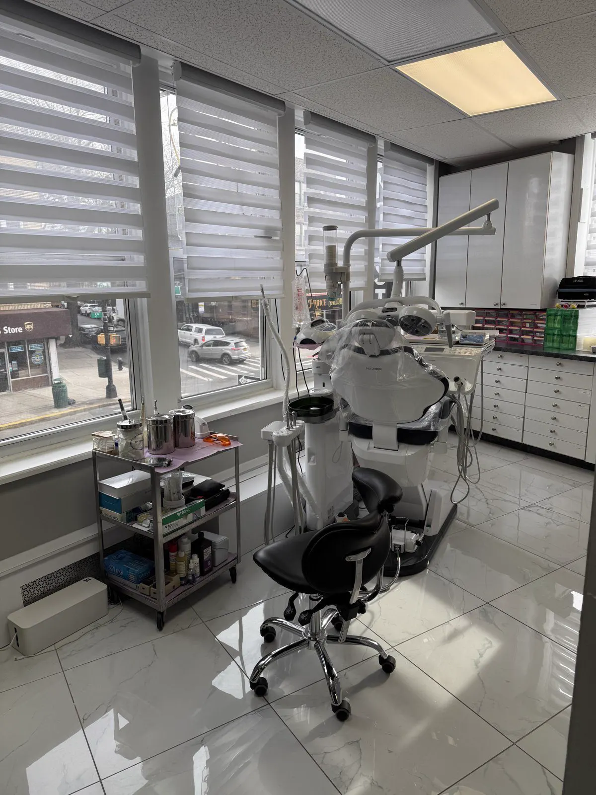 A bright, modern treatment room with large windows at Dental Art Care