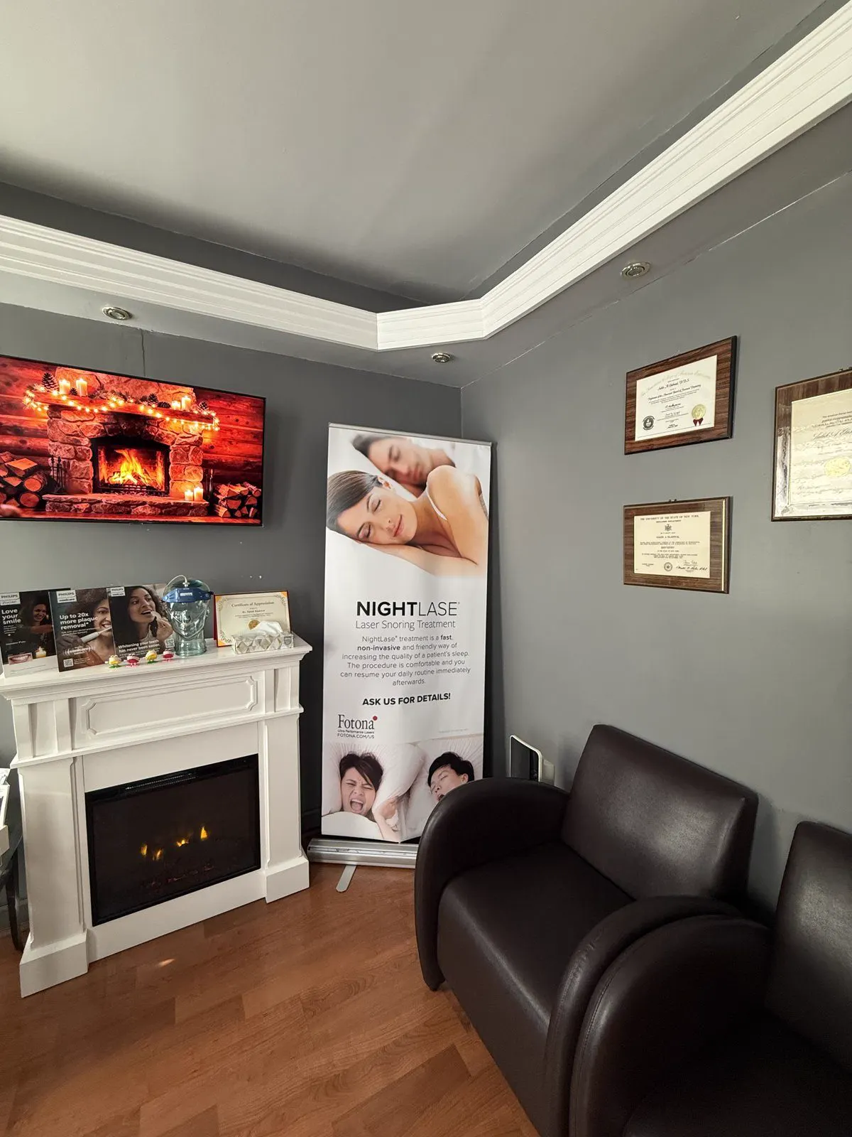 A comfortable seating area at Dental Art Care with Dr. Elahwal's diplomas on the wall